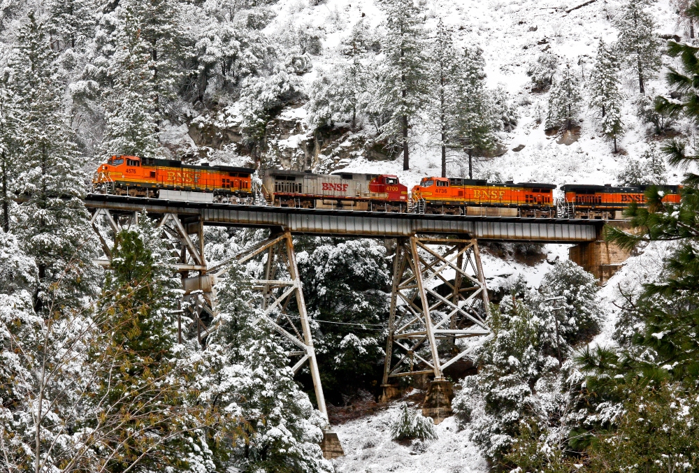 A BNSF train crosses the Rock Creek Trestle on a snowy day in the Feather River Canyon.